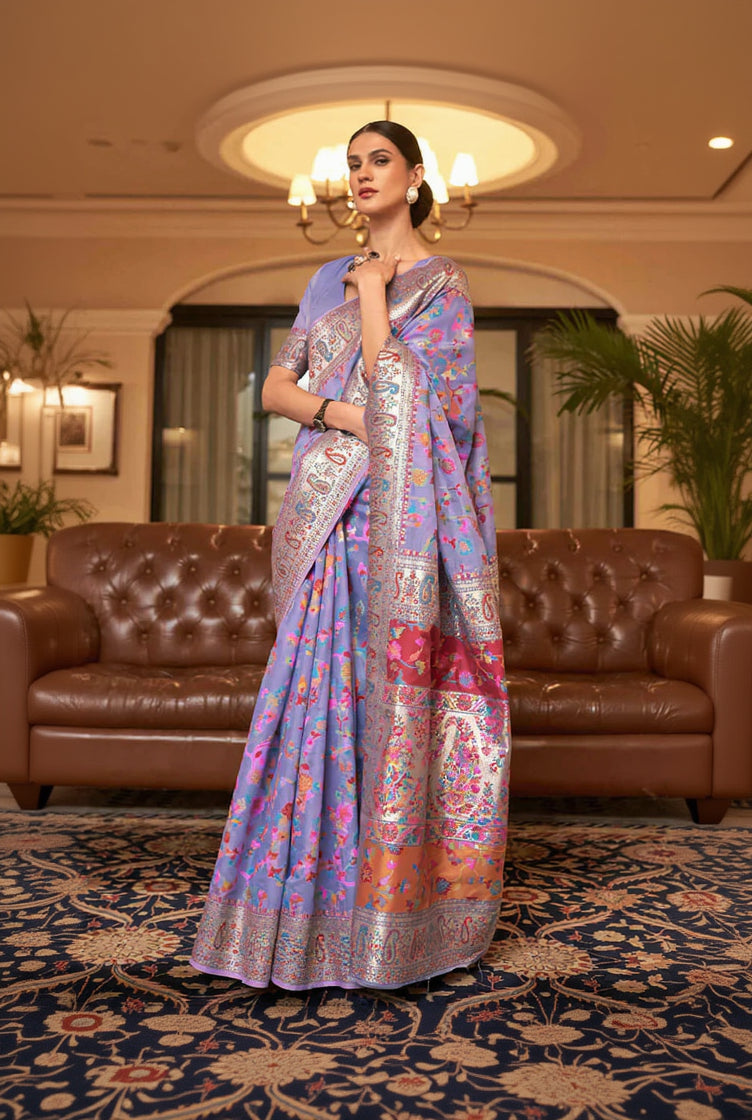 Woman wearing a colorful saree in an elegant indoor setting