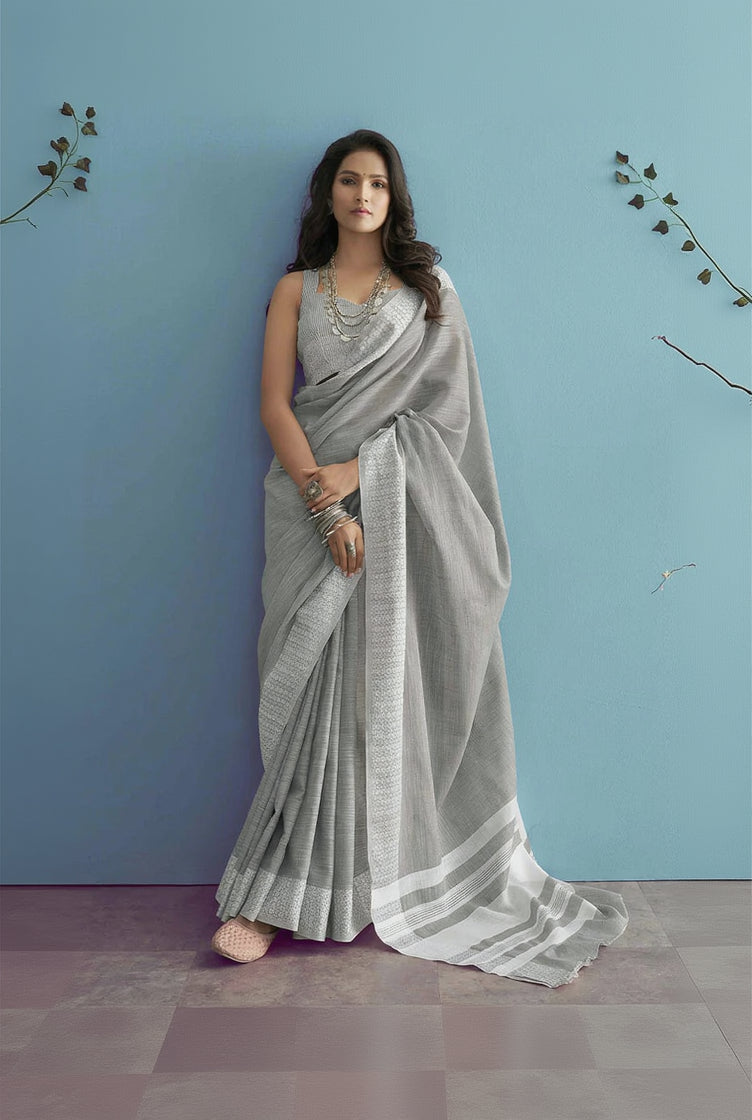 Woman wearing a gray saree with a blue background