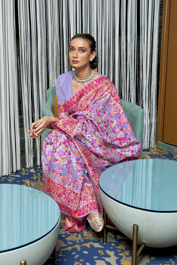 Woman in a colorful saree sitting in a modern interior setting