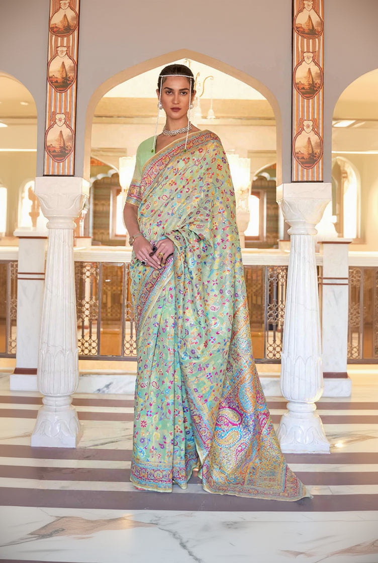 Woman wearing a colorful saree in an ornate interior setting